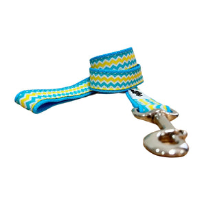 Dog leash featuring a blue, yellow and white waves pattern on baby blue webbing.