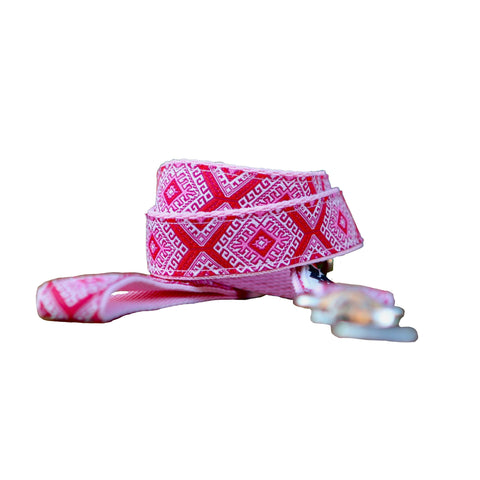 Dog leash featuring an Aztec themed ribbon on baby pink webbing.