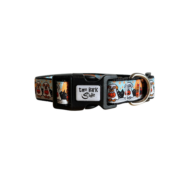Dog collar featuring a spooky Halloween themed design on a multi coloured ribbon. The collar has black webbing and buckle.