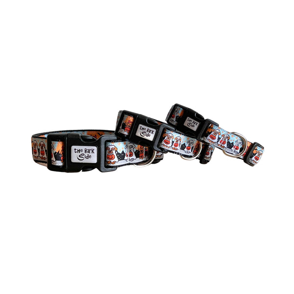 Three different sized dog collars featuring a spooky Halloween themed design on a multi coloured ribbon. The collars have black webbing and buckles.