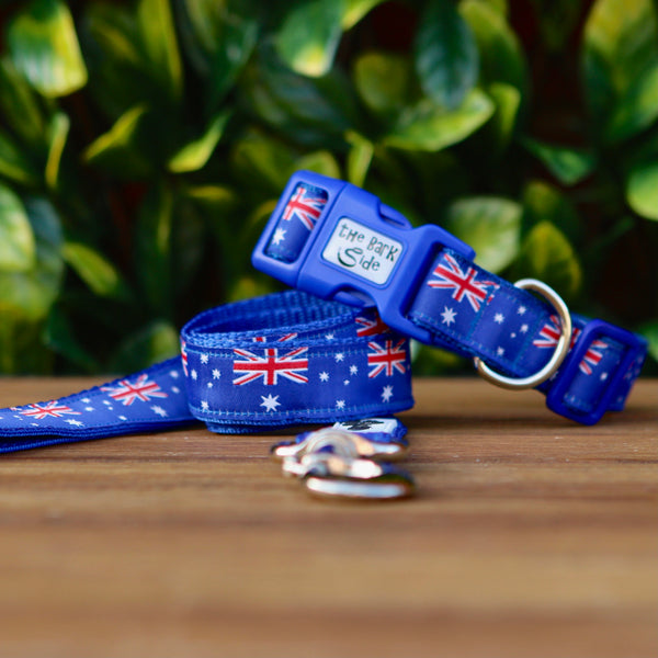 Dog collar and leash featuring a blue ribbon adorned with Australian Flags. The collar and leash are on blue webbing.