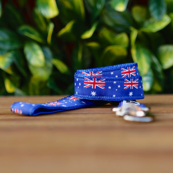 Dog leash featuring a blue ribbon adorned with Australian Flags. The leash is on blue webbing and has a heavy duty snaphook.