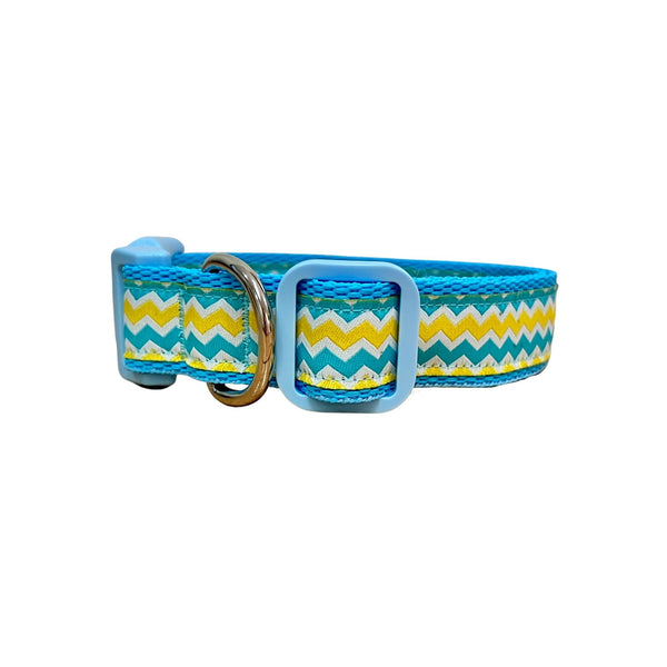 Dog collar featuring a blue, yellow and white wave themed ribbon on baby blue webbing.
