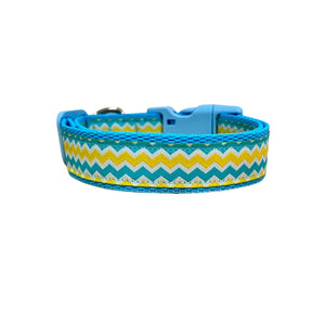 Dog collar featuring a blue, yellow and white wave themed ribbon on baby blue webbing.