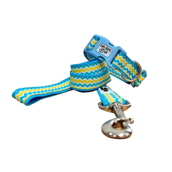 Dog collar and leash featuring a blue, yellow and white wave themed ribbon on baby blue webbing.