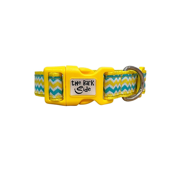 Dog collar featuring a blue, yellow and white wave themed ribbon on yellow webbing.