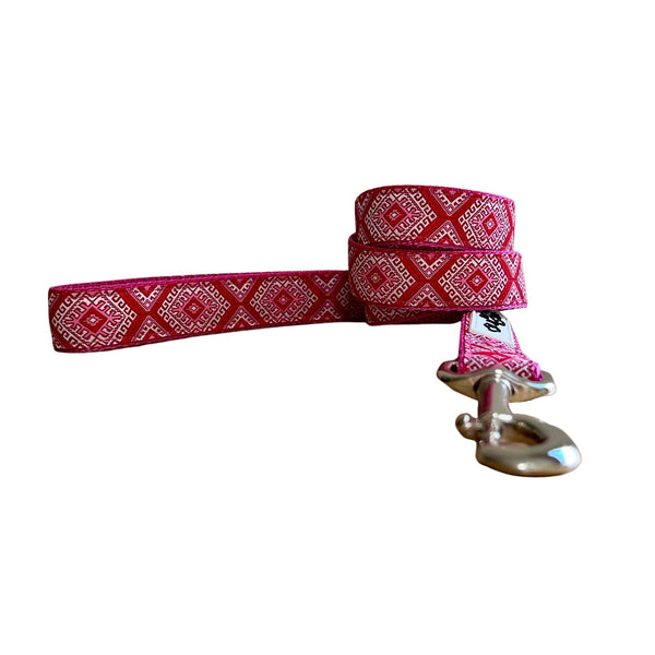 Dog leash featuring an Aztec themed ribbon on dark pink webbing.