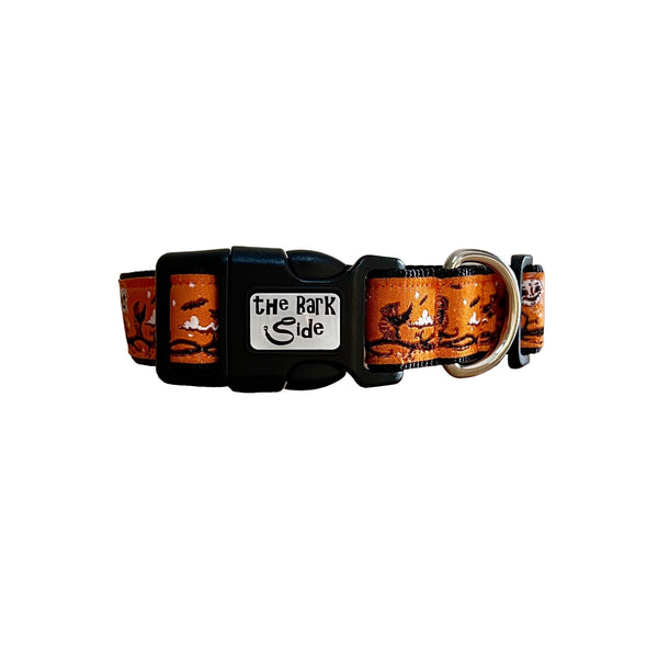 Dog collar featuring a spooky Halloween themed design on an orange ribbon. The collar has black webbing and buckle.