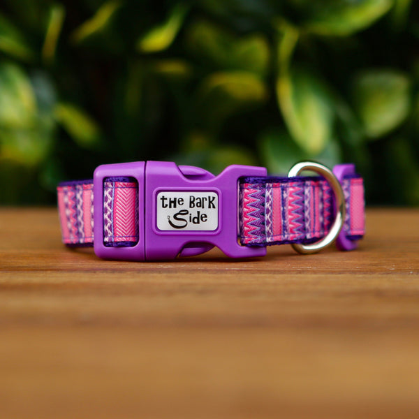 Dog collar featuring a vibrant pink and purple Aztec themed ribbon on purple webbing.