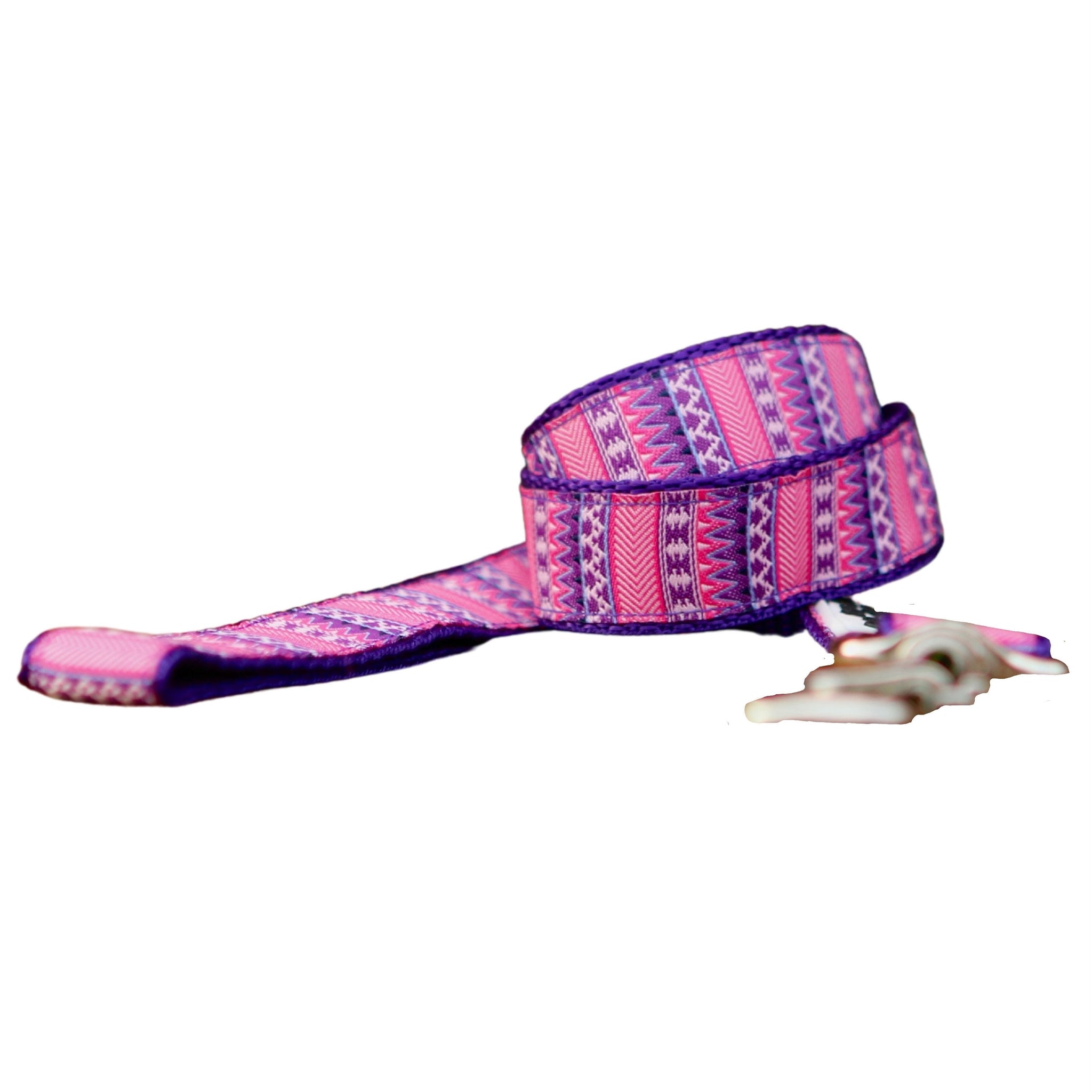 Dog leash featuring a vibrant pink and purple Aztec themed ribbon on purple webbing.