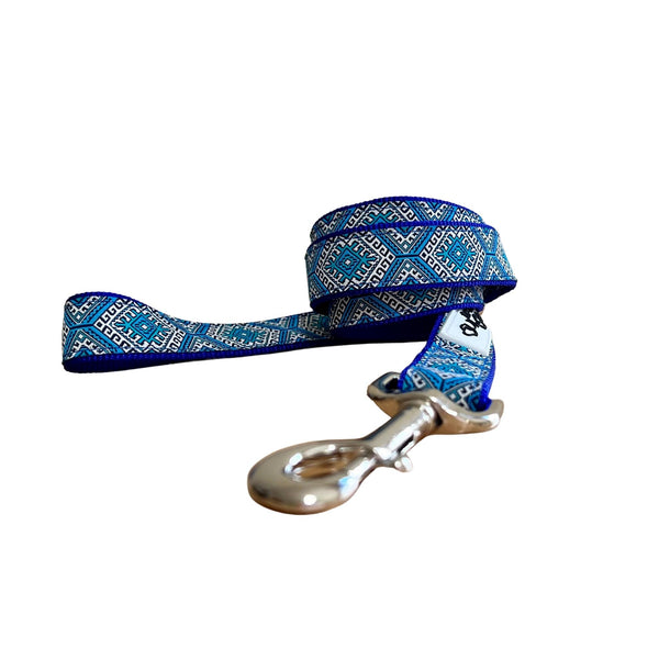 Dog leash featuring an Aztec themed ribbon on royal blue webbing.